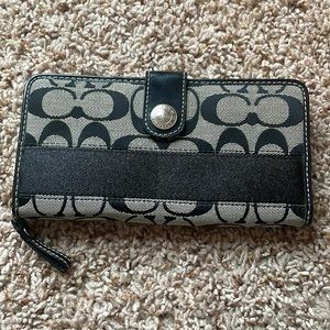 Black and grey coach wallet.